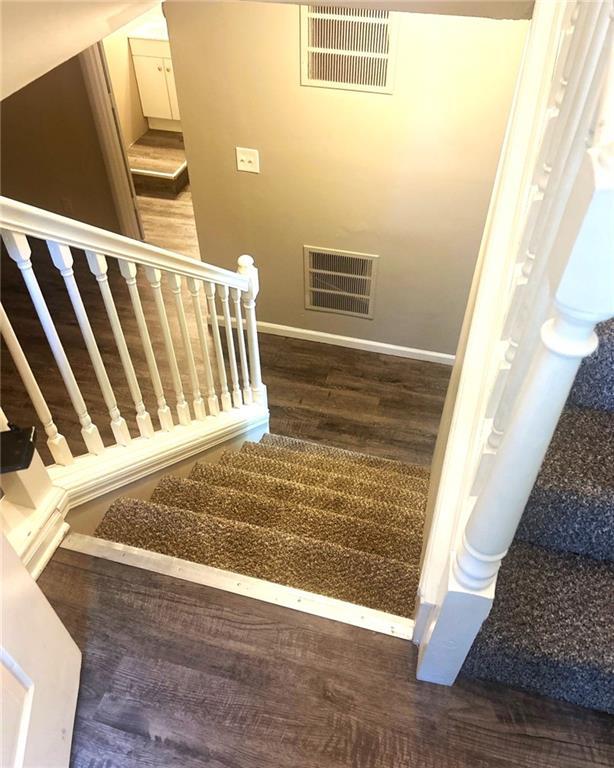 10636 N Grand Ave, Kansas City, MO 64155 - stairs with wood finished floors and baseboards