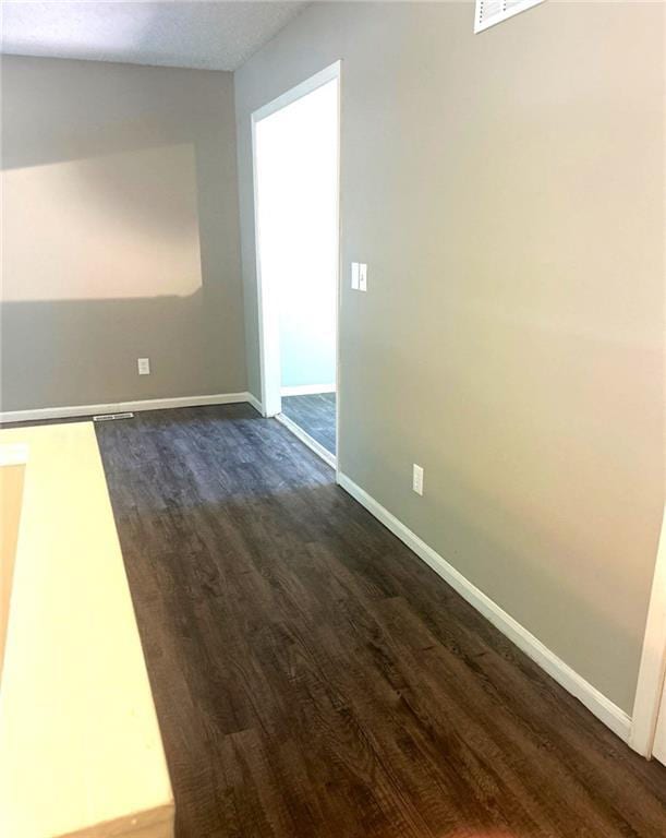 10636 N Grand Ave, Kansas City, MO 64155 - unfurnished room featuring dark wood-style flooring and baseboards