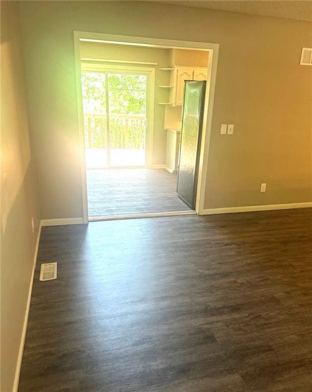 10636 N Grand Ave, Kansas City, MO 64155 - unfurnished room featuring baseboards and dark wood finished floors