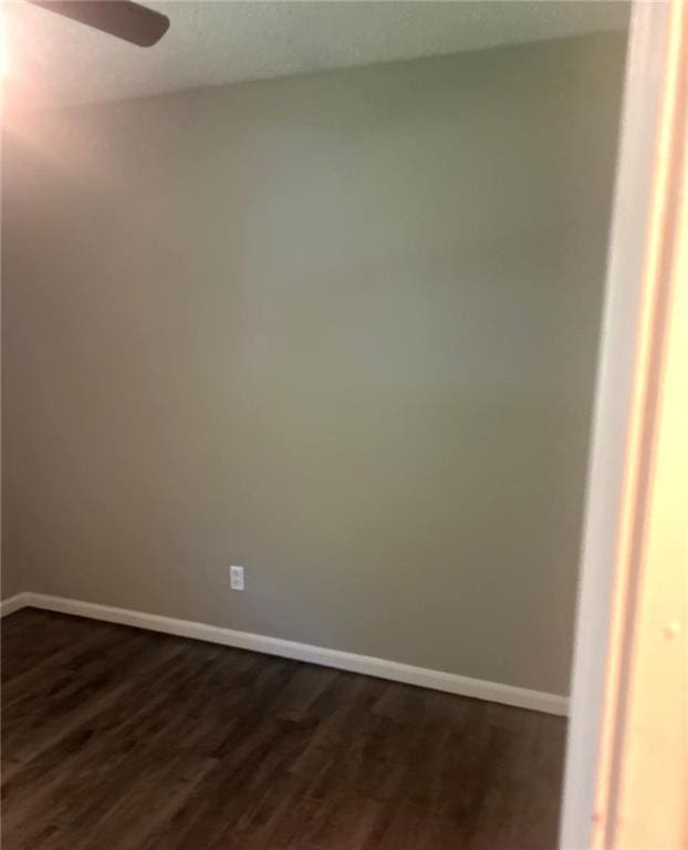10636 N Grand Ave, Kansas City, MO 64155 - empty room featuring baseboards, dark wood-style flooring, and a ceiling fan