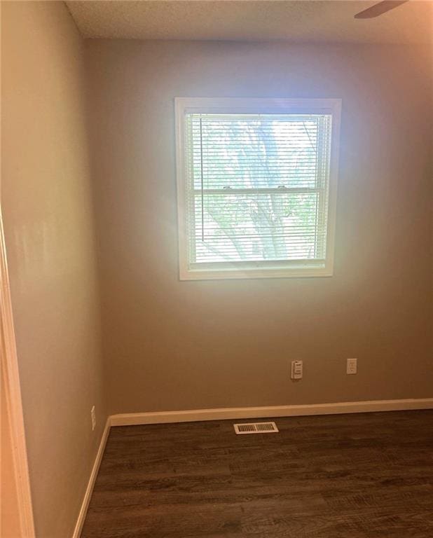 10636 N Grand Ave, Kansas City, MO 64155 - spare room with dark wood-style flooring and baseboards