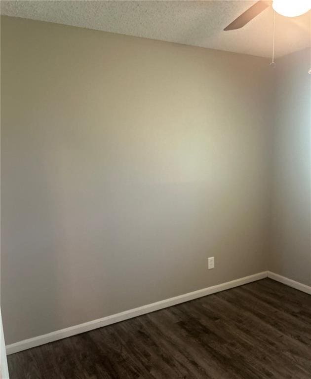 10636 N Grand Ave, Kansas City, MO 64155 - spare room with dark wood-type flooring, baseboards, a ceiling fan, and a textured ceiling