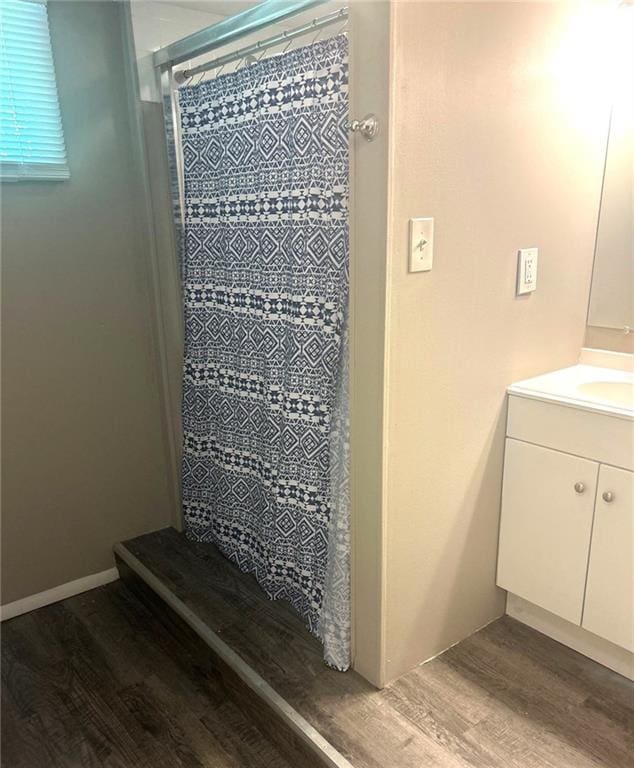 10636 N Grand Ave, Kansas City, MO 64155 - bathroom view of wood finished floors, vanity, and a stall shower