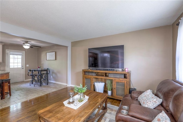 606 W Smith St, Spring Hill, KS 66083 - living room with light wood-style flooring, a ceiling fan, and a textured ceiling