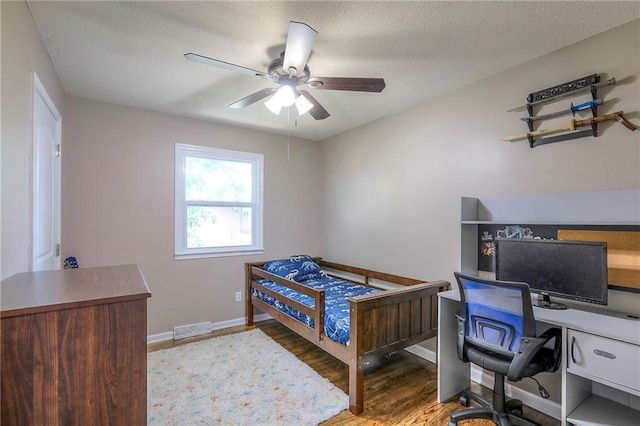 606 W Smith St, Spring Hill, KS 66083 - bedroom featuring wood finished floors, an office area, a textured ceiling, and a ceiling fan