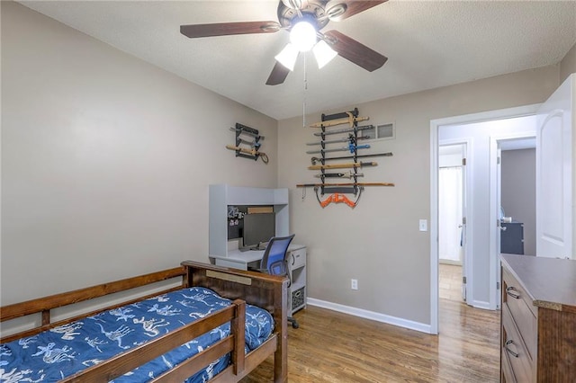 606 W Smith St, Spring Hill, KS 66083 - bedroom with wood finished floors and a ceiling fan