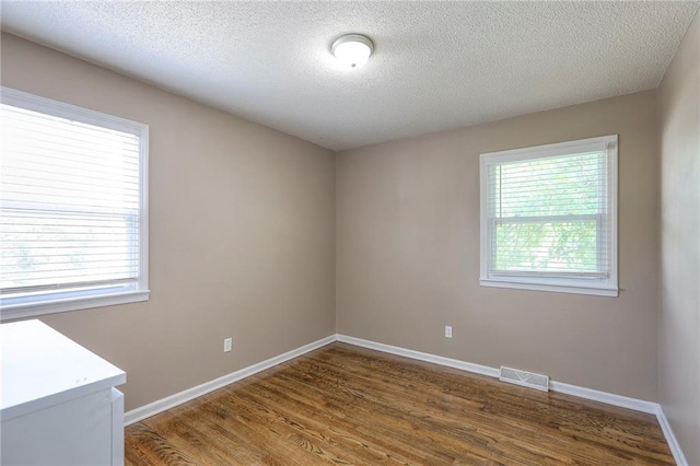 606 W Smith St, Spring Hill, KS 66083 - empty room featuring wood finished floors and a textured ceiling