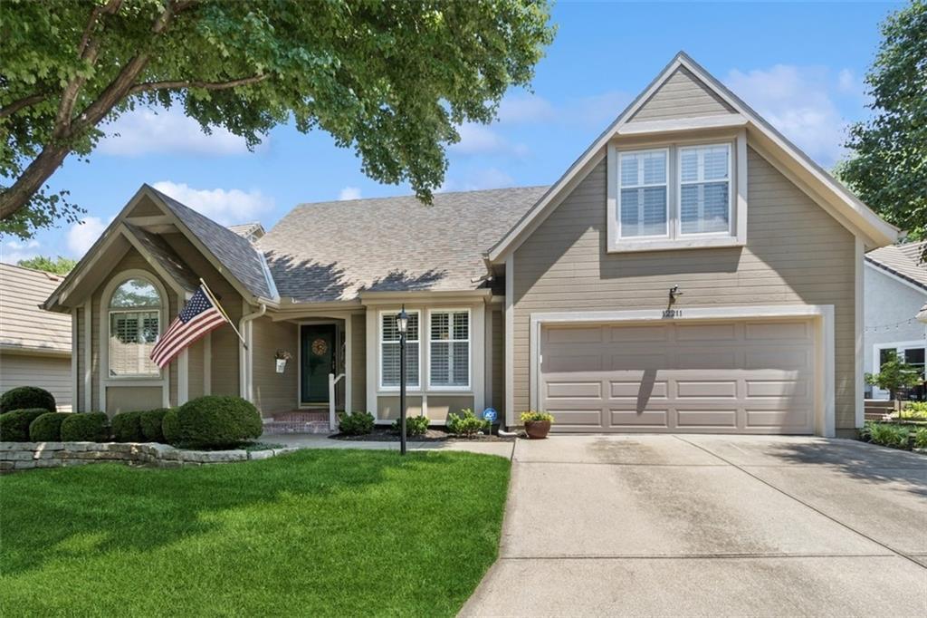 12211 Sagamore Rd, Leawood, KS 66209 - traditional-style home with a front yard, driveway, and a garage