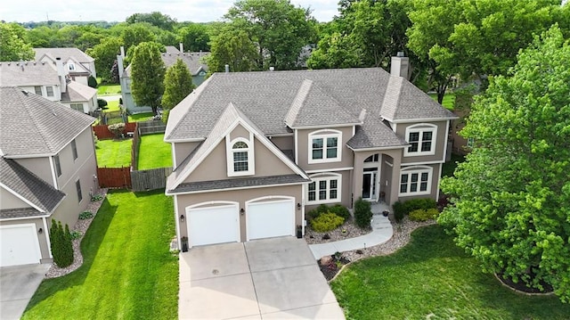 3832 SW Boulder Dr, Lees Summit, MO 64082 - french country home with stucco siding, concrete driveway, a chimney, a garage, and a shingled roof