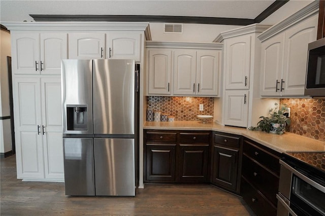 3832 SW Boulder Dr, Lees Summit, MO 64082 - kitchen featuring appliances with stainless steel finishes, dark wood-style flooring, tasteful backsplash, light countertops, and ornamental molding
