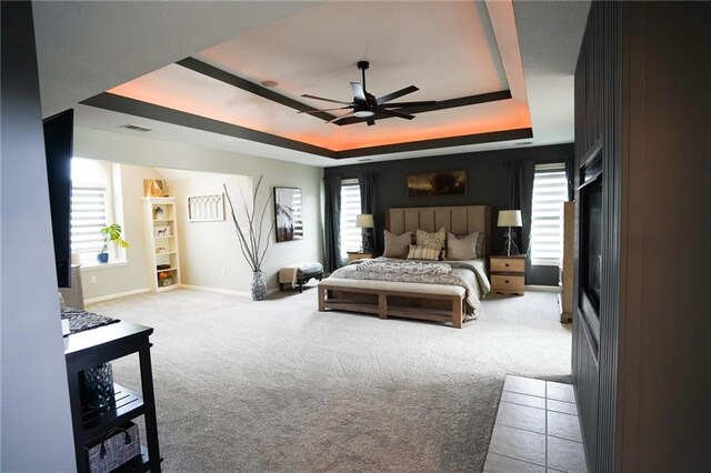 3832 SW Boulder Dr, Lees Summit, MO 64082 - carpeted bedroom with a raised ceiling, baseboards, and ceiling fan
