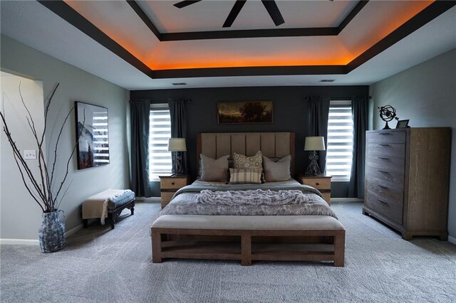 3832 SW Boulder Dr, Lees Summit, MO 64082 - carpeted bedroom with a raised ceiling, multiple windows, and baseboards