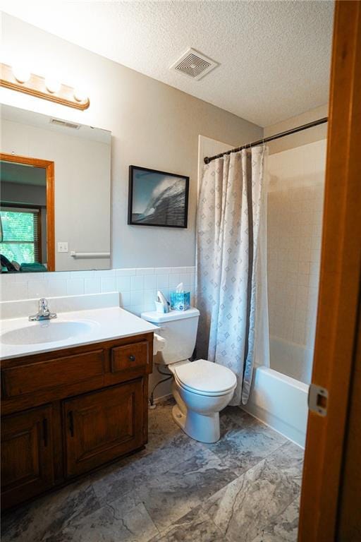 3832 SW Boulder Dr, Lees Summit, MO 64082 - full bathroom with toilet, vanity, tile walls, shower / bath combo with shower curtain, and a textured ceiling