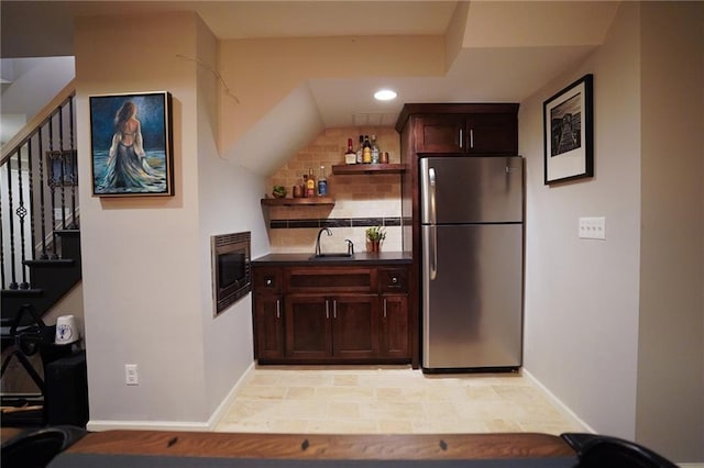3832 SW Boulder Dr, Lees Summit, MO 64082 - kitchen with appliances with stainless steel finishes, a sink, dark countertops, open shelves, and dark brown cabinets