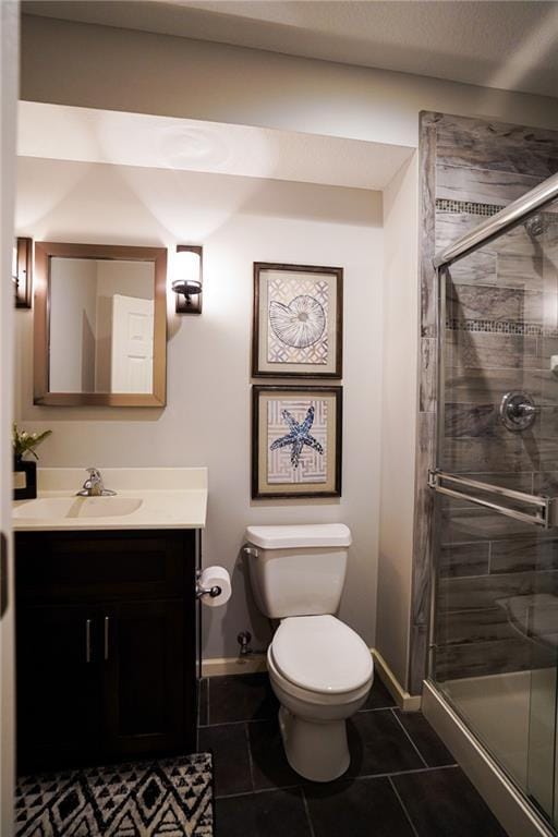 3832 SW Boulder Dr, Lees Summit, MO 64082 - full bathroom featuring toilet, vanity, tile patterned floors, baseboards, and a stall shower