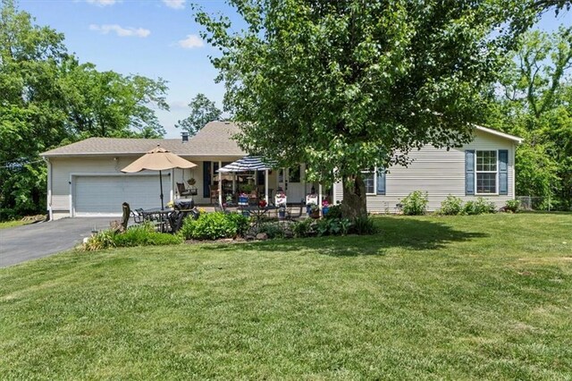6246 Woodland Dr, Shawnee, KS 66218 - view of front facade featuring asphalt driveway, an attached garage, and a front lawn