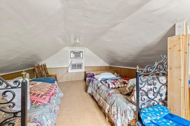 6246 Woodland Dr, Shawnee, KS 66218 - carpeted bedroom with vaulted ceiling, wood walls, and a wall mounted air conditioner