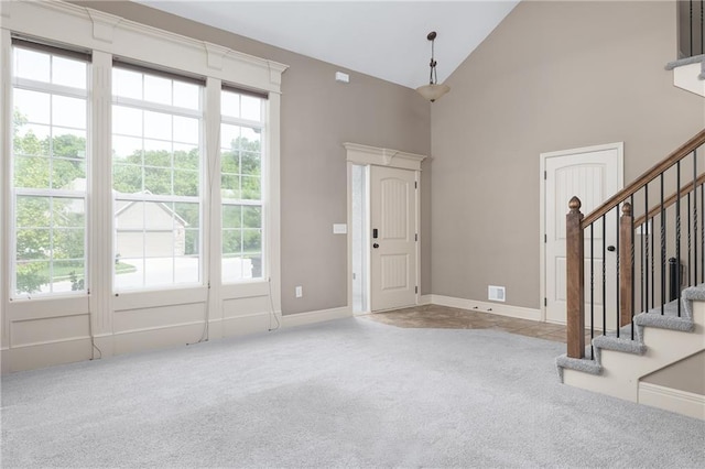 486 S 137th Pl, Bonner Springs, KS 66012 - carpeted entrance foyer featuring plenty of natural light, stairs, baseboards, and high vaulted ceiling