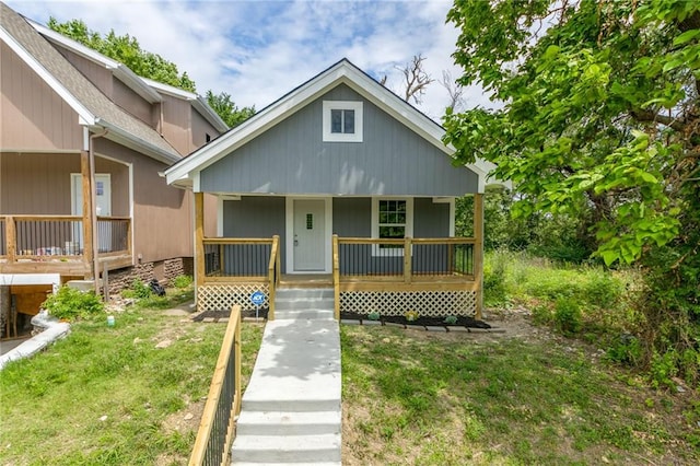 4233 Euclid Ave, Kansas City, MO 64130 - bungalow with covered porch and a front lawn