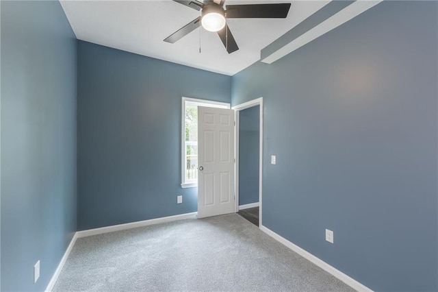 4233 Euclid Ave, Kansas City, MO 64130 - spare room featuring a ceiling fan, baseboards, and carpet