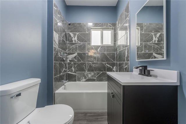 4233 Euclid Ave, Kansas City, MO 64130 - bathroom with toilet, vanity,  shower combination, and wood finished floors