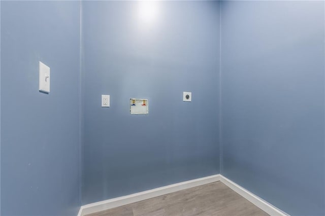 4233 Euclid Ave, Kansas City, MO 64130 - washroom featuring hookup for an electric dryer, washer hookup, baseboards, and light wood-style floors