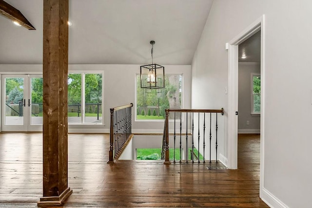 2308 W 95th St, Leawood, KS 66206 - unfurnished dining area featuring lofted ceiling, healthy amount of natural light, hardwood / wood-style flooring, french doors, and a chandelier