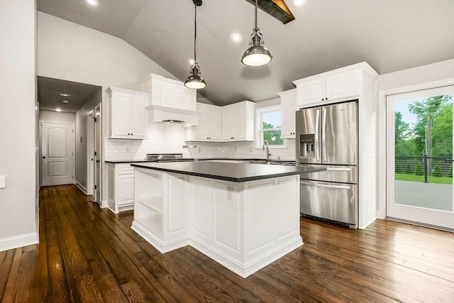 2308 W 95th St, Leawood, KS 66206 - kitchen featuring stainless steel fridge, dark countertops, lofted ceiling, a kitchen island, and white cabinetry