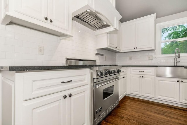 2308 W 95th St, Leawood, KS 66206 - kitchen featuring designer range, wall chimney range hood, dark countertops, and backsplash