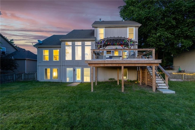 5916 NE Turquoise Dr, Lees Summit, MO 64064 - back of property at dusk featuring stairs, a deck, and a shingled roof
