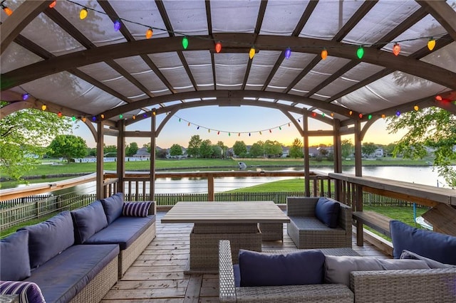 5916 NE Turquoise Dr, Lees Summit, MO 64064 - deck at dusk with outdoor lounge area and a water view