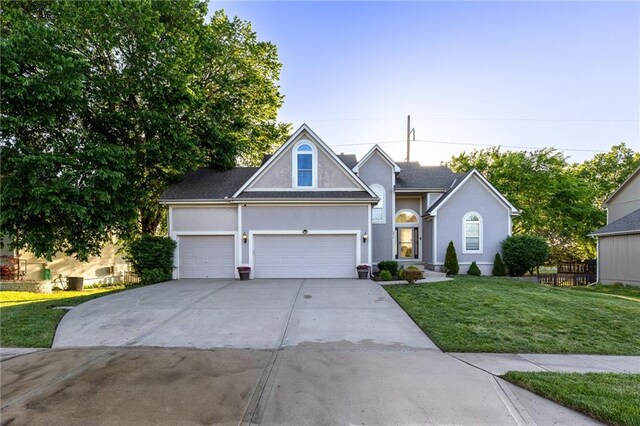 5916 NE Turquoise Dr, Lees Summit, MO 64064 - traditional-style house with concrete driveway, a front yard, an attached garage, and stucco siding