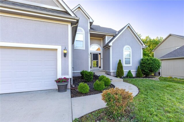 5916 NE Turquoise Dr, Lees Summit, MO 64064 - view of front facade featuring a front yard, stucco siding, and concrete driveway