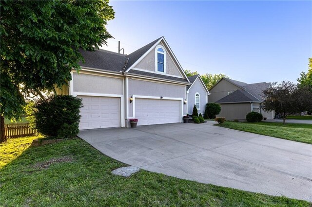 5916 NE Turquoise Dr, Lees Summit, MO 64064 - traditional-style home featuring concrete driveway, stucco siding, and an attached garage