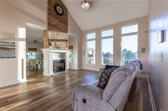 5916 NE Turquoise Dr, Lees Summit, MO 64064 - living room with high vaulted ceiling, healthy amount of natural light, dark wood-style floors, and baseboards