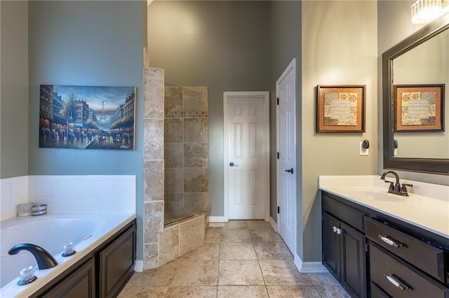 5916 NE Turquoise Dr, Lees Summit, MO 64064 - bathroom featuring a garden tub, vanity, tiled shower, and baseboards