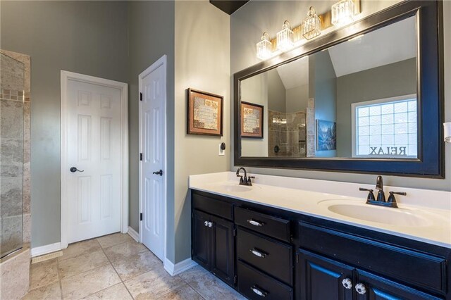 5916 NE Turquoise Dr, Lees Summit, MO 64064 - bathroom with double vanity, tiled shower, and baseboards
