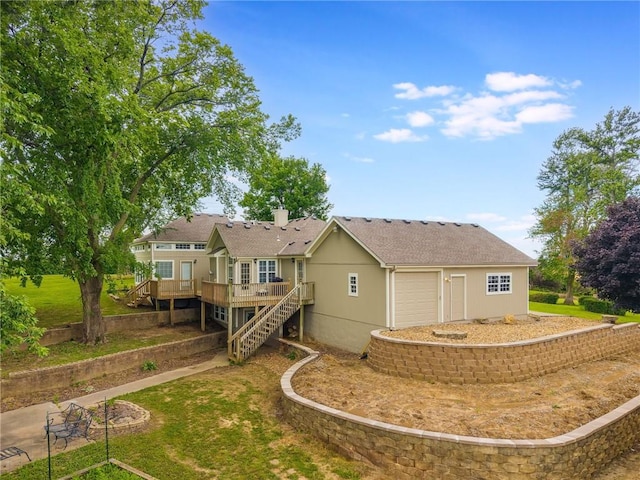 1955 Birmingham Rd, Liberty, MO 64068 - back of house featuring an attached garage, stairway, a deck, stucco siding, and a chimney