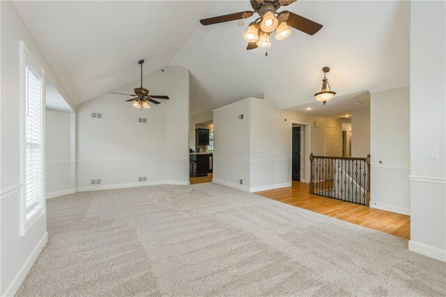 1955 Birmingham Rd, Liberty, MO 64068 - unfurnished living room with ceiling fan, carpet, healthy amount of natural light, and high vaulted ceiling