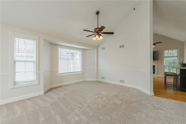 1955 Birmingham Rd, Liberty, MO 64068 - carpeted spare room with a ceiling fan, lofted ceiling, and a fireplace