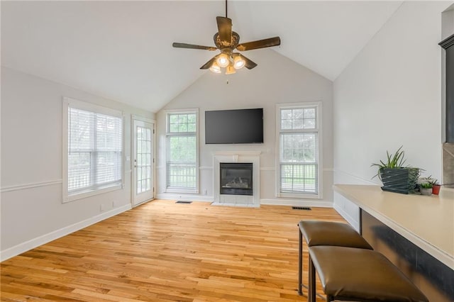 1955 Birmingham Rd, Liberty, MO 64068 - living room with a fireplace with flush hearth, ceiling fan, light wood finished floors, and lofted ceiling