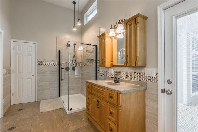 1955 Birmingham Rd, Liberty, MO 64068 - full bathroom featuring vanity, a stall shower, tile patterned floors, a towering ceiling, and tile walls