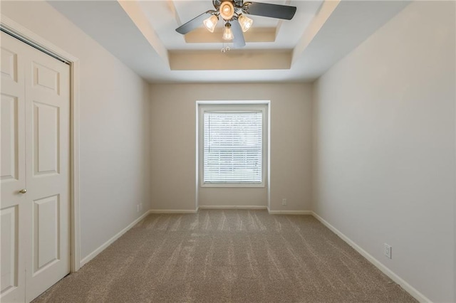 1955 Birmingham Rd, Liberty, MO 64068 - empty room with a tray ceiling, carpet, and ceiling fan