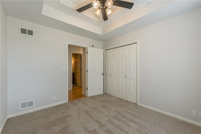 1955 Birmingham Rd, Liberty, MO 64068 - unfurnished bedroom featuring carpet floors, a raised ceiling, a closet, and ceiling fan