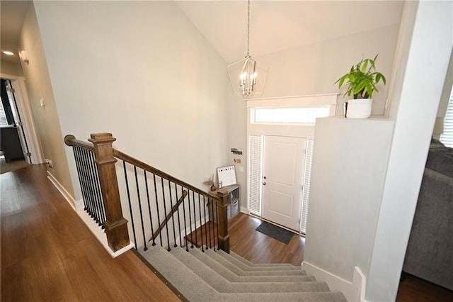 1905 Eagle Dr, Harrisonville, MO 64701 - entrance foyer featuring a chandelier, wood finished floors, baseboards, high vaulted ceiling, and stairway
