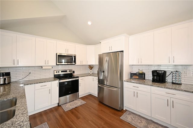1905 Eagle Dr, Harrisonville, MO 64701 - kitchen featuring appliances with stainless steel finishes, white cabinetry, vaulted ceiling, light stone countertops, and recessed lighting
