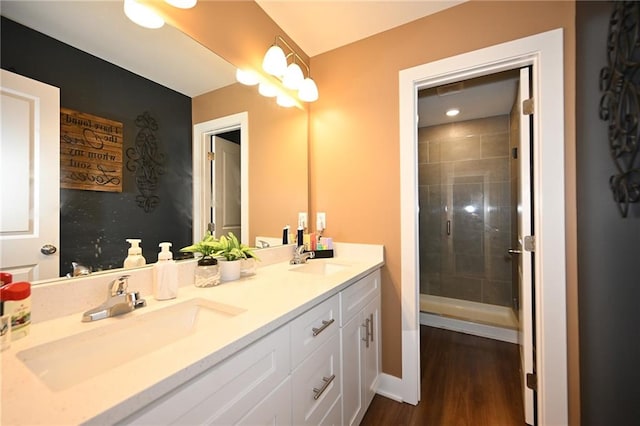 1905 Eagle Dr, Harrisonville, MO 64701 - full bath featuring double vanity, a stall shower, and wood finished floors