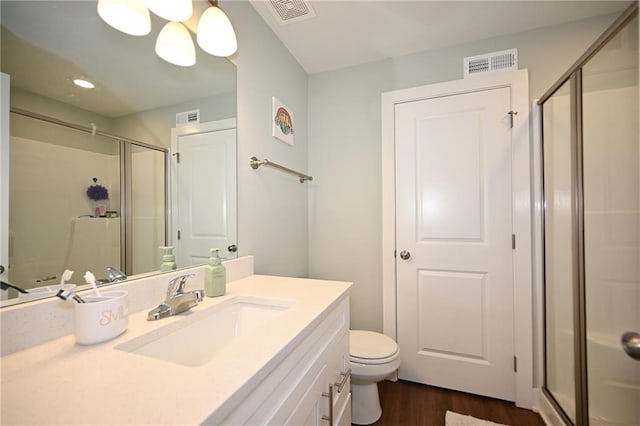 1905 Eagle Dr, Harrisonville, MO 64701 - bathroom featuring wood finished floors, a stall shower, vanity, toilet, and recessed lighting