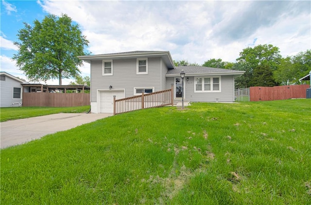 2917 N 83rd Ter, Kansas City, KS 66109 - rear view of house with an attached garage and concrete driveway