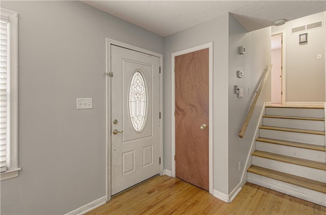 2917 N 83rd Ter, Kansas City, KS 66109 - entrance foyer with light wood-style floors, baseboards, and stairs